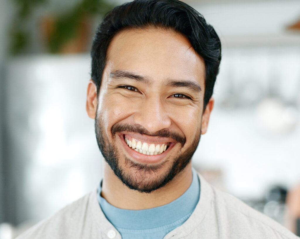 Smiling man showing healthy teeth after visiting a holistic dentist in Oklahoma