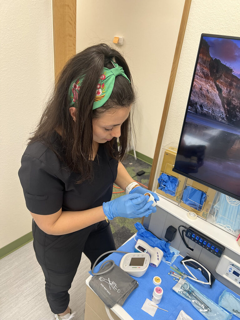 Dental assistant preparing a procedure room at Apollonia Dental for holistic health and functional medicine care