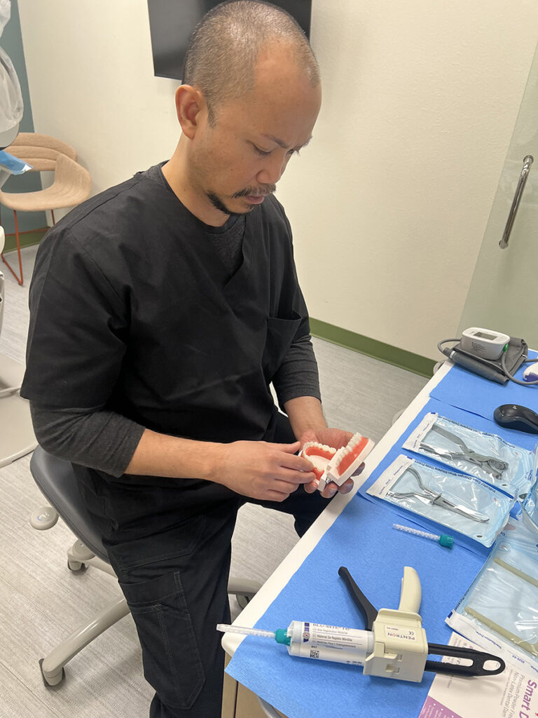 Dental assistant preparing tools in a holistic dentist office in Oklahoma