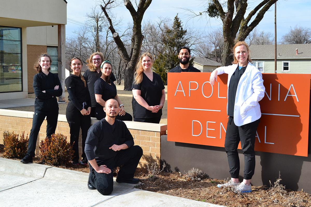 Apollonia Dental team standing in front of office marquee, united in their mission to support holistic health and functional medicine
